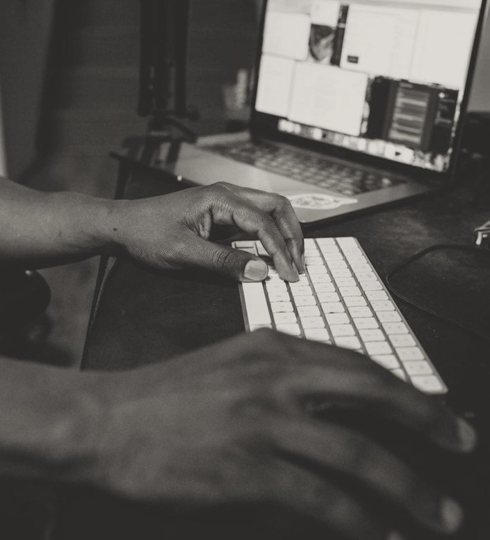 Hands working at a laptop keyboard
