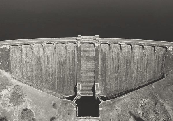 A concrete dam spillway seen from above
